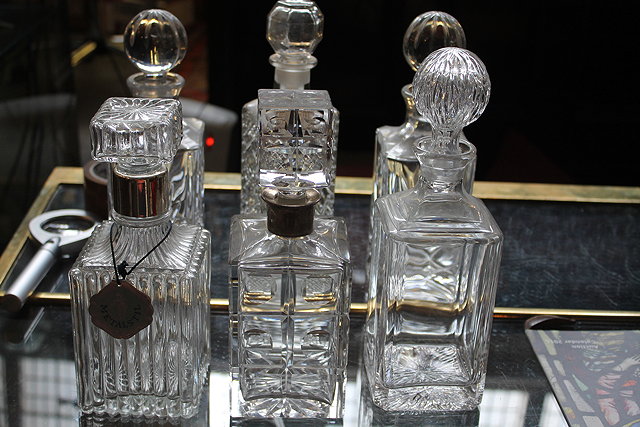 Appraisal: A PAIR OF SQUARE GLASS DECANTERS each with silver collars