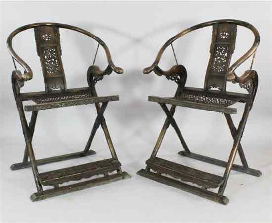 Appraisal: A pair Chinese horseshoe shaped folding chairs the central splats