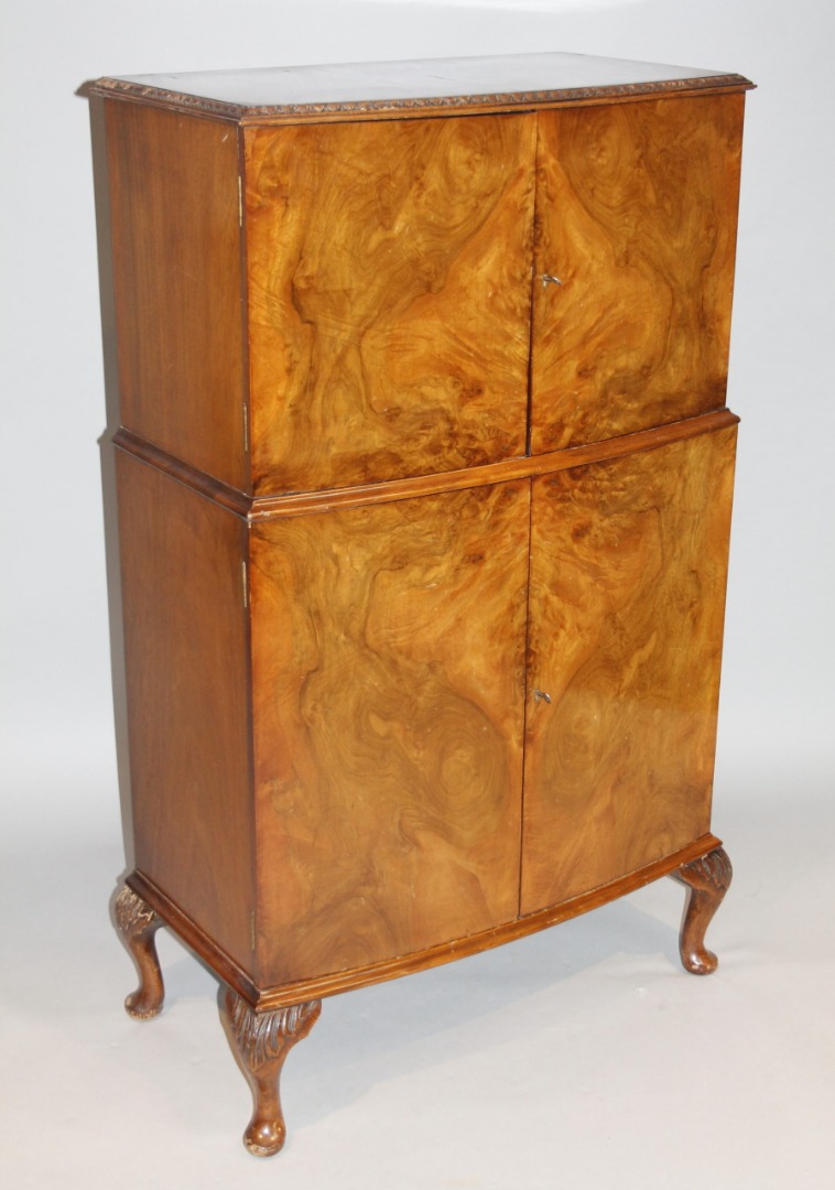 Appraisal: A mid- thC walnut veneered cocktail cabinet of bow fronted