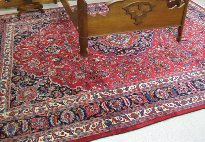 Appraisal: PERSIAN MASHAD CARPET floral and central floral medallion design on