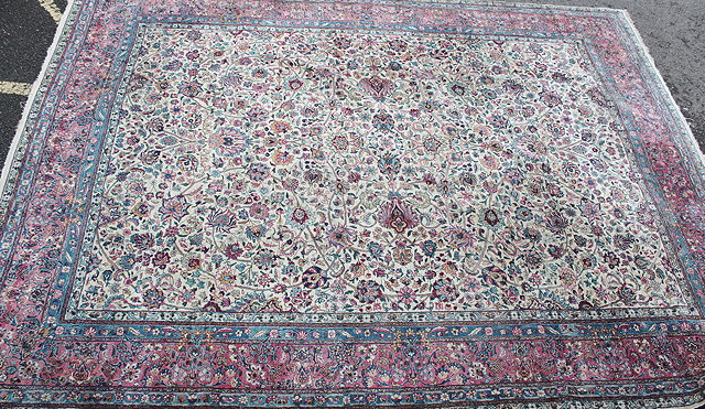 Appraisal: A KIRMAN WHITE GROUND LARGE CARPET within intense foliate design