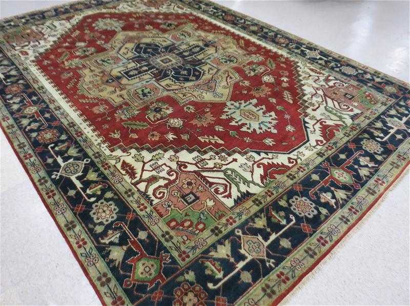 Appraisal: HAND KNOTTED ORIENTAL CARPET Persian Serapi design central geometric medallion