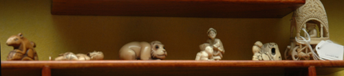 Appraisal: A COLLECTION OF FIVE IVORY NETSUKE AND A BONE CARRIAGE