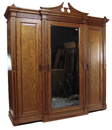 Appraisal: A neo-classical satinwood wardrobe the broken pediment over moulded cornice