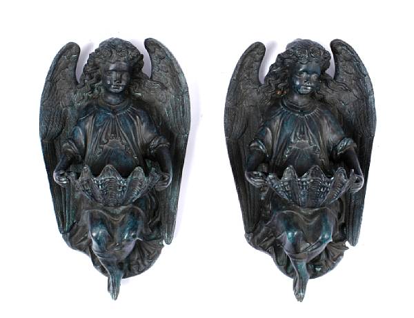 Appraisal: A pair of polychrome bronze cherubs wall mounts with shell