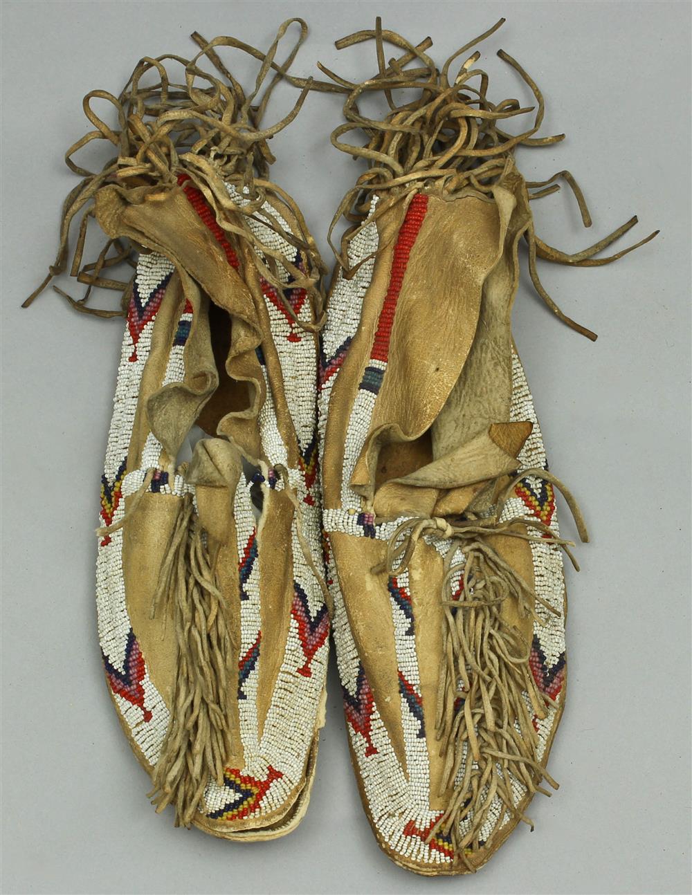 Appraisal: NATIVE AMERICAN BEADED AND FRINGED HIDE MOCCASINS Cheyenne last quarter