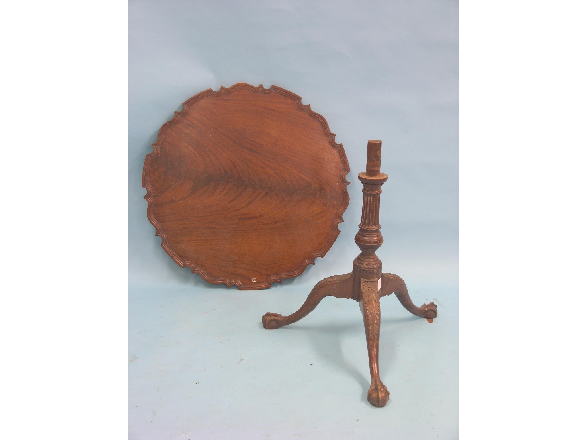 Appraisal: A Chippendale-style mahogany tripod table circular flame-figured top with pie-crust