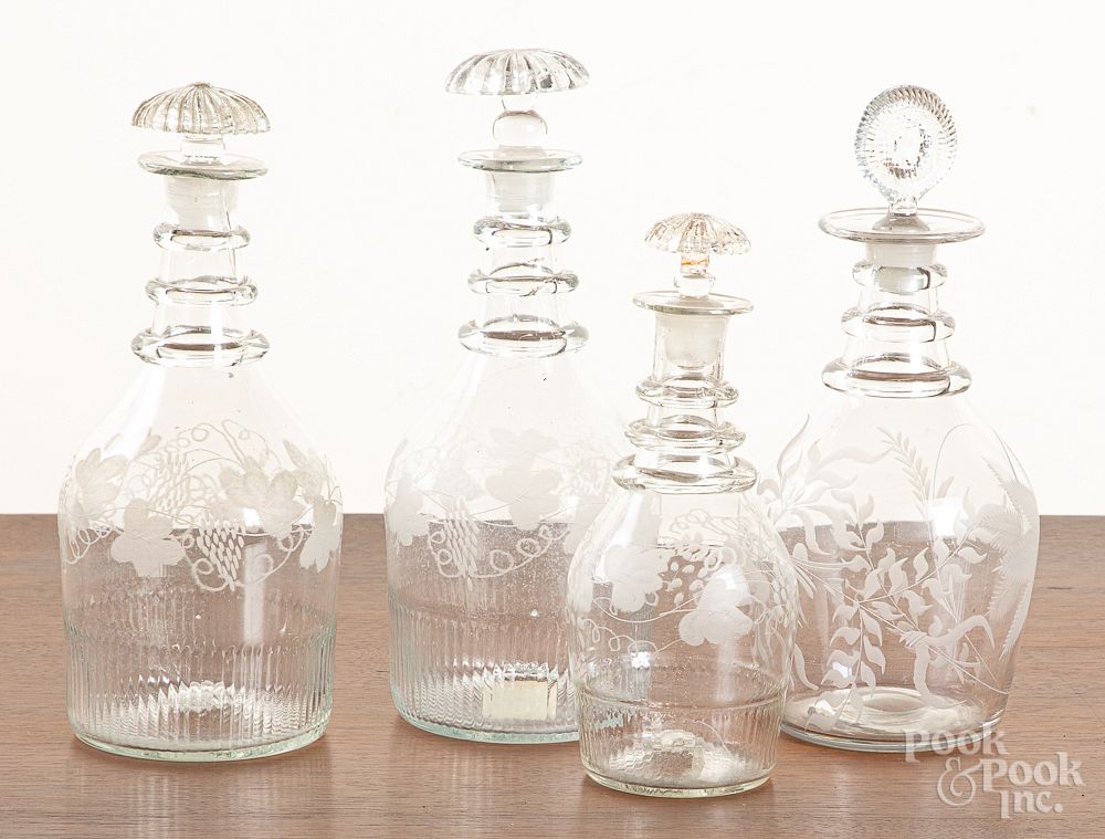 Appraisal: Four etched colorless glass decanters Four etched colorless glass decanters