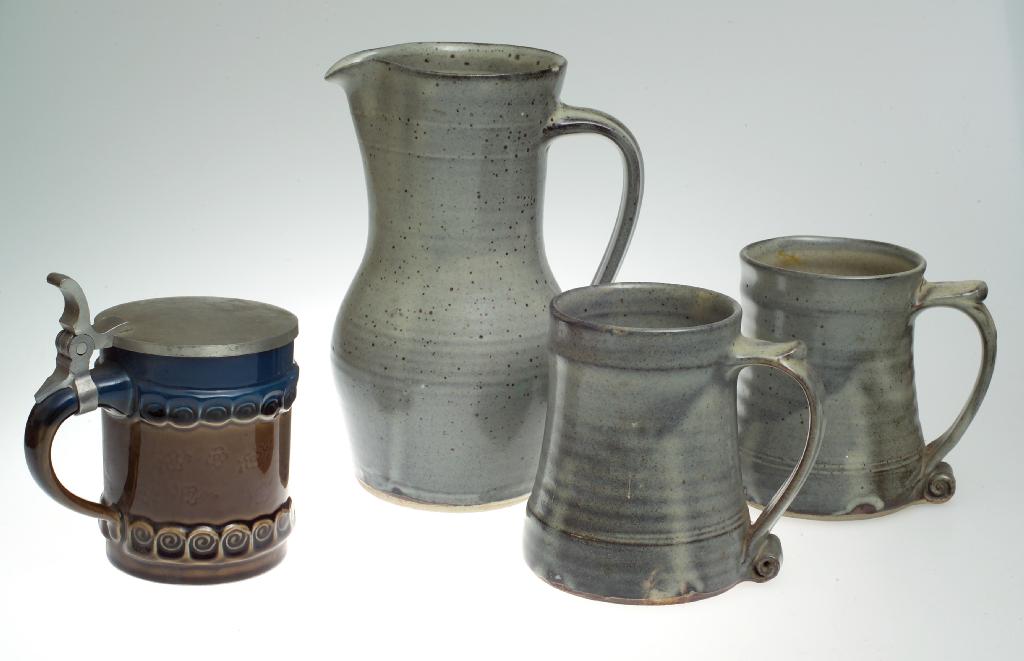 Appraisal: BERNARD LEACH STUDIO POTTERY JUG AND TWO MUGS the jug