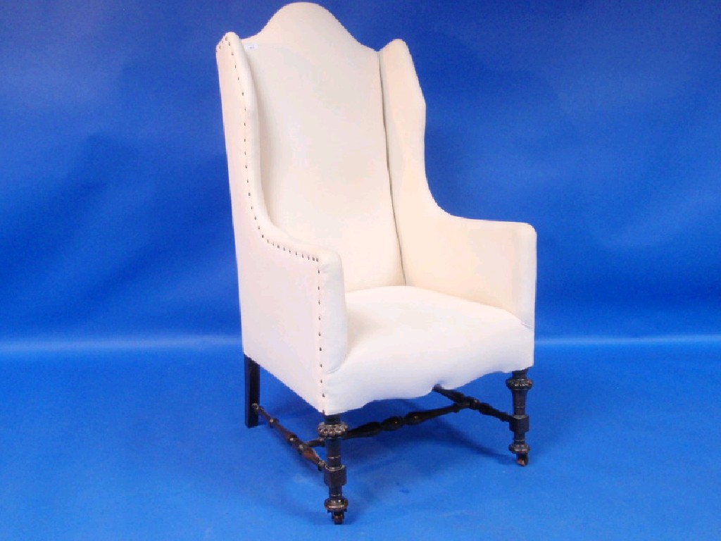 Appraisal: A William and Mary-style high-back armchair with turned and carved