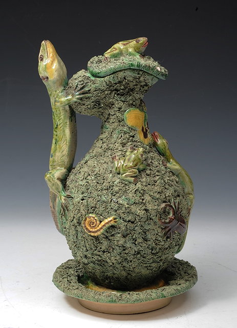 Appraisal: A PORTUGUESE PALISSY STYLE JUG cover and stand the moss