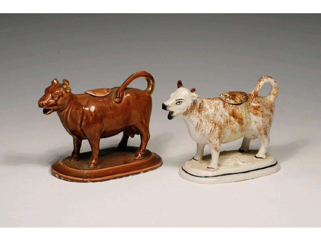 Appraisal: A STAFFORDSHIRE POTTERY COW CREAMER AND COVER modelled with brown