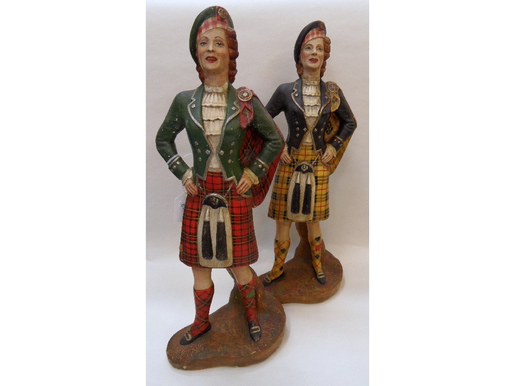 Appraisal: Two large painted plaster figures of women in Highland dress