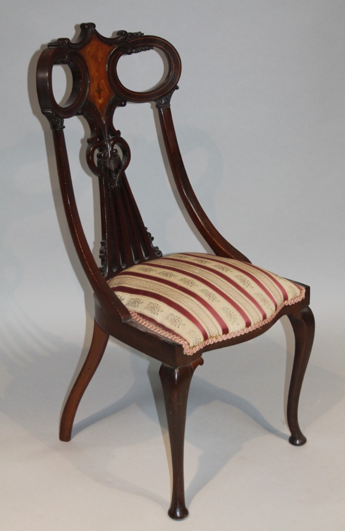 Appraisal: An Edwardian mahogany walnut and boxwood strung salon chair with