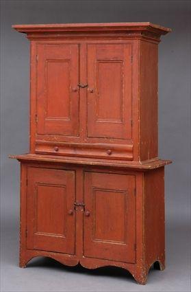 Appraisal: RED-STAINED PINE TWO-PART CABINET POSSIBLY CANADIAN The overhang cornice above