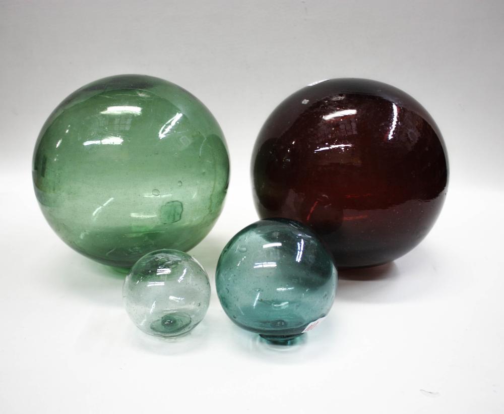 Appraisal: FOUR JAPANESE GLASS FISHING FLOATS larger floats one in green