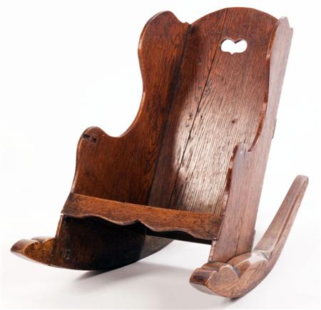 Appraisal: A Welsh oak child's wing back rocking chair the arched