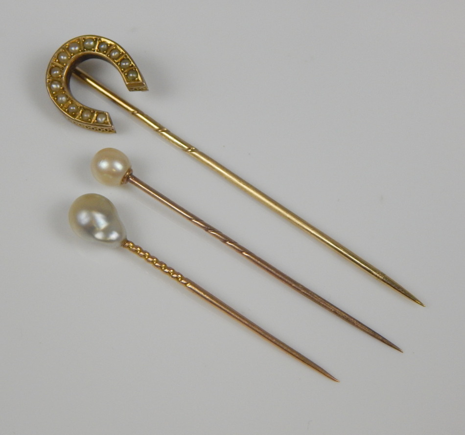 Appraisal: Three stick pins to include a horseshoe pin set with