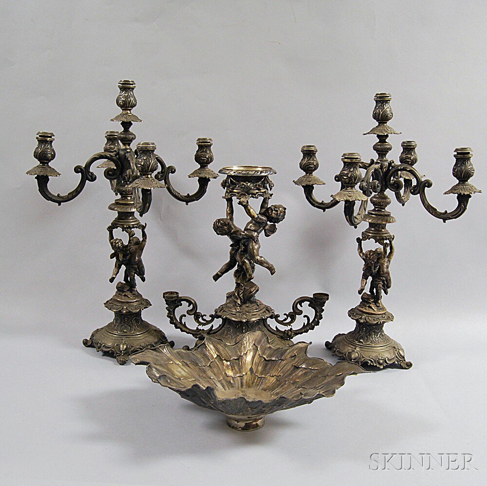 Appraisal: German Silver Garniture with Putto Decoration two convertible five-light candelabras