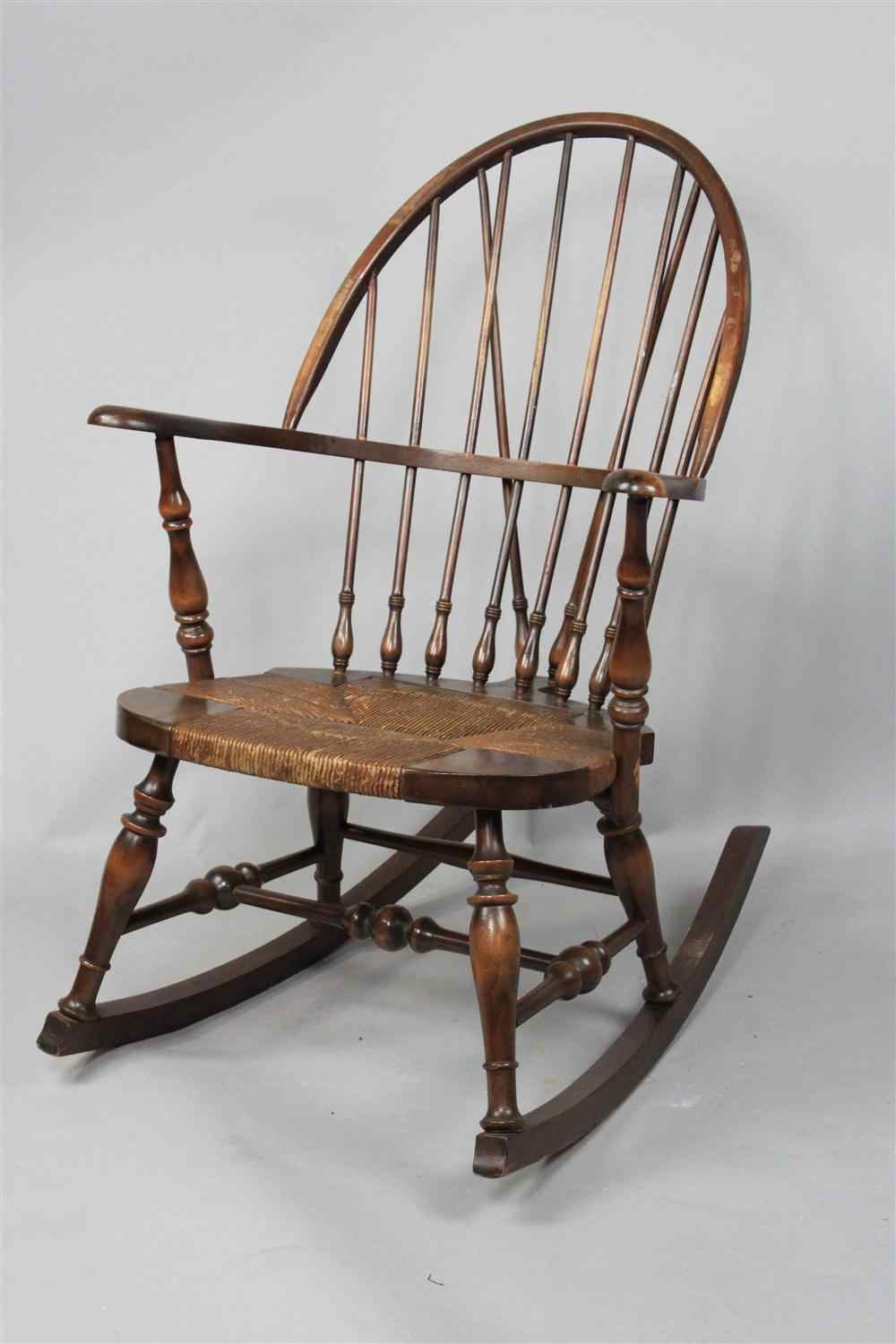 Appraisal: WINDSOR ROCKER WITH RUSHED SEAT hoop back with continuous arm