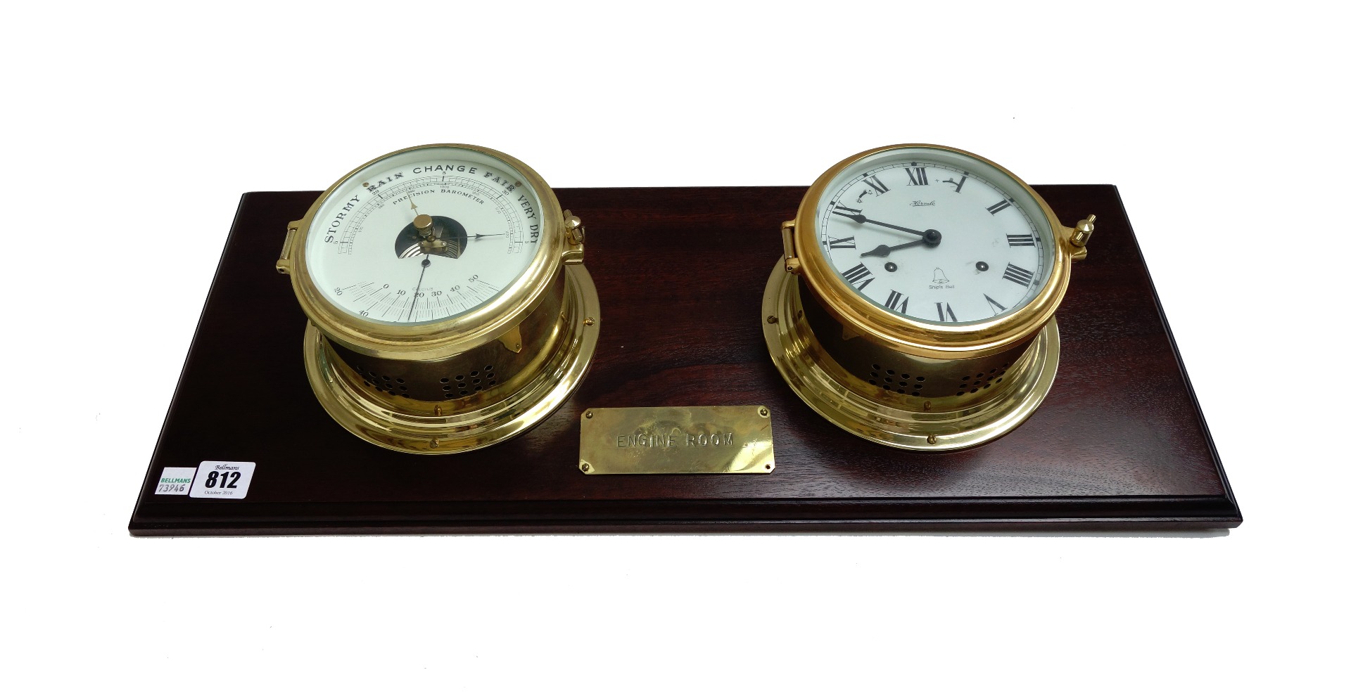 Appraisal: A modern brass ship's clock and matching barometer mounted on