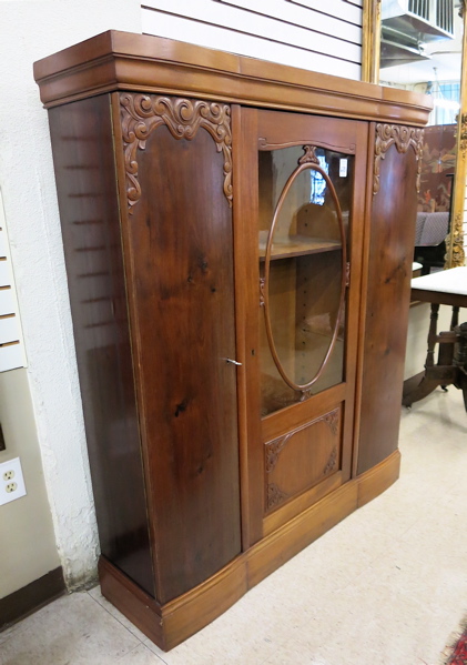 Appraisal: A MAHOGANY THREE-DOOR CABINET BOOKCASE German c centering a glass