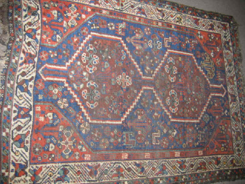 Appraisal: SHIRAZ THROW RUG The abrashed navy blue field shows a