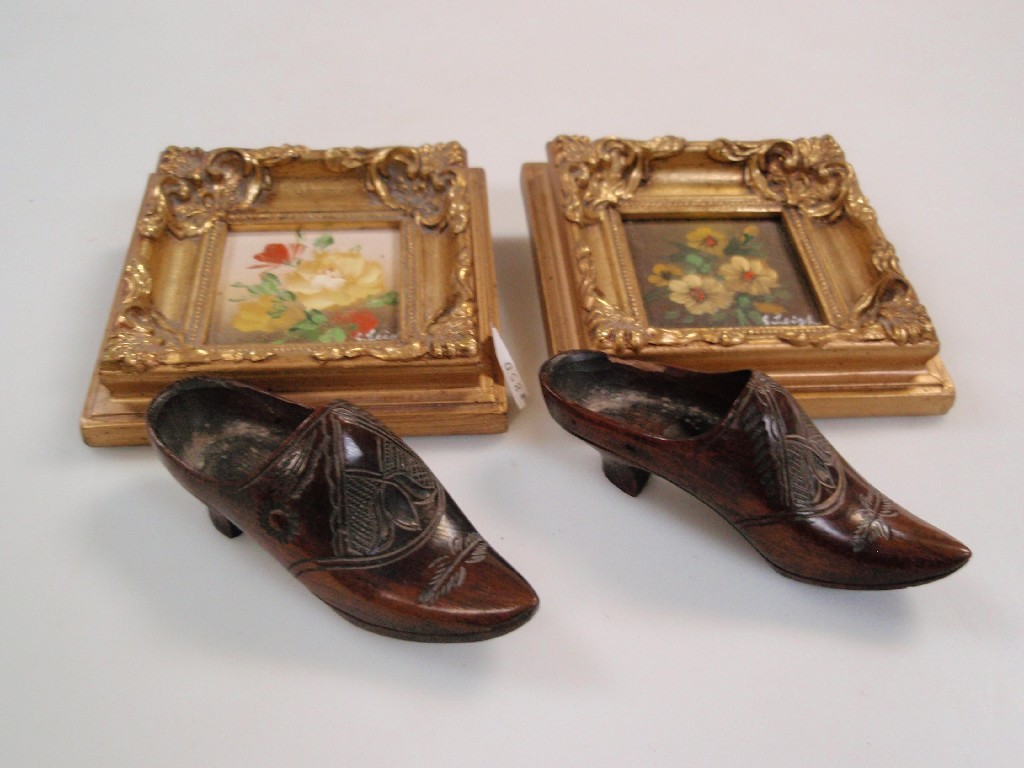 Appraisal: A pair of treen miniature shoes engraved with foliate detail