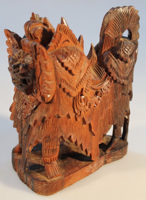 Appraisal: A Balinese carved hardwood figure of a temple lion on