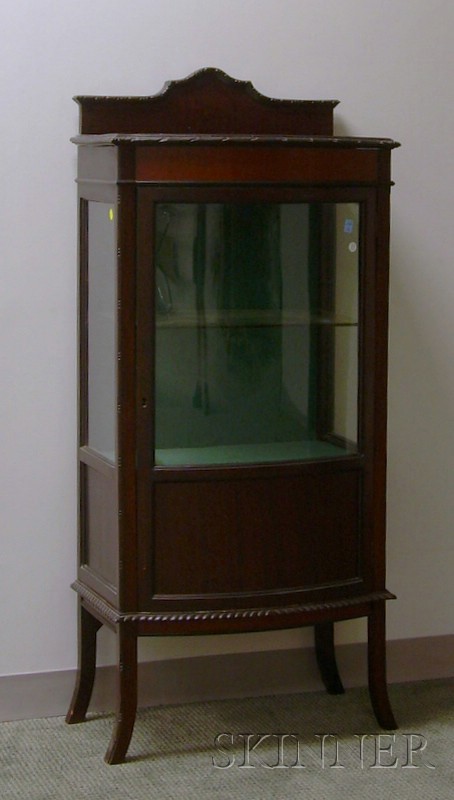 Appraisal: Georgian-style Carved Mahogany Bowfront Display Cabinet the interior with one