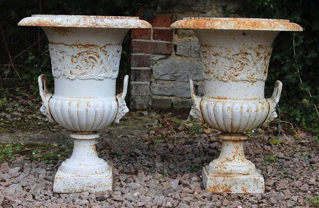 Appraisal: A PAIR OF CAST IRON URNS of campana form with