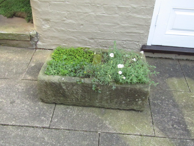 Appraisal: A hand hewn stone rectangular trough with divider cm x