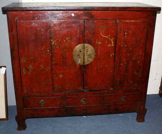 Appraisal: A CHINESE RED LACQUERED CABINET the interior fitted shelves enclosed