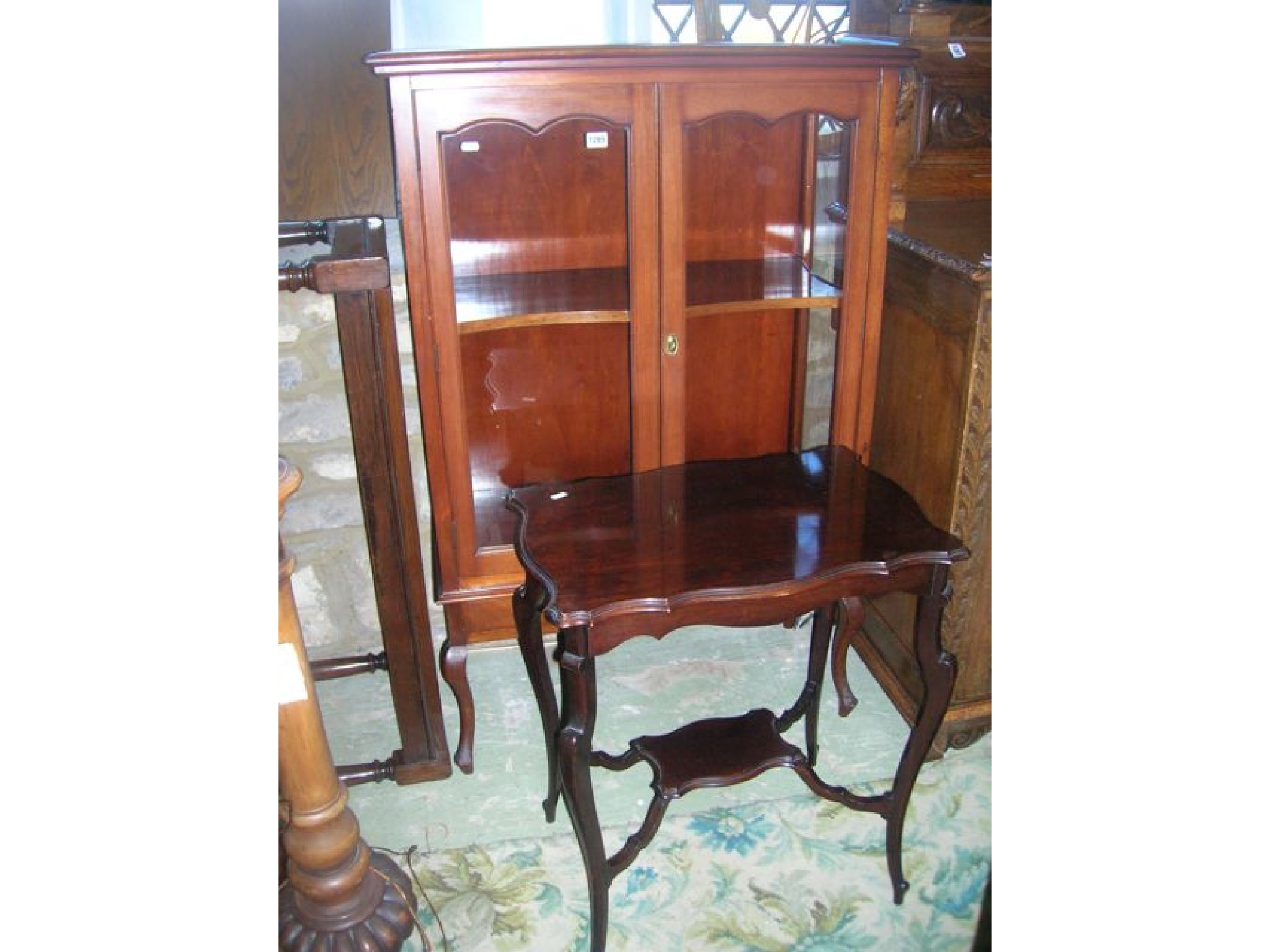 Appraisal: An Edwardian mahogany display cabinet freestanding and enclosed by a