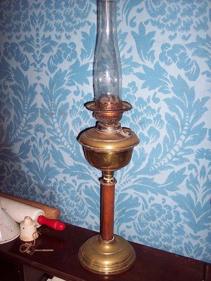 Appraisal: A brass oil lamp the reservoir in a cylindrical wooden