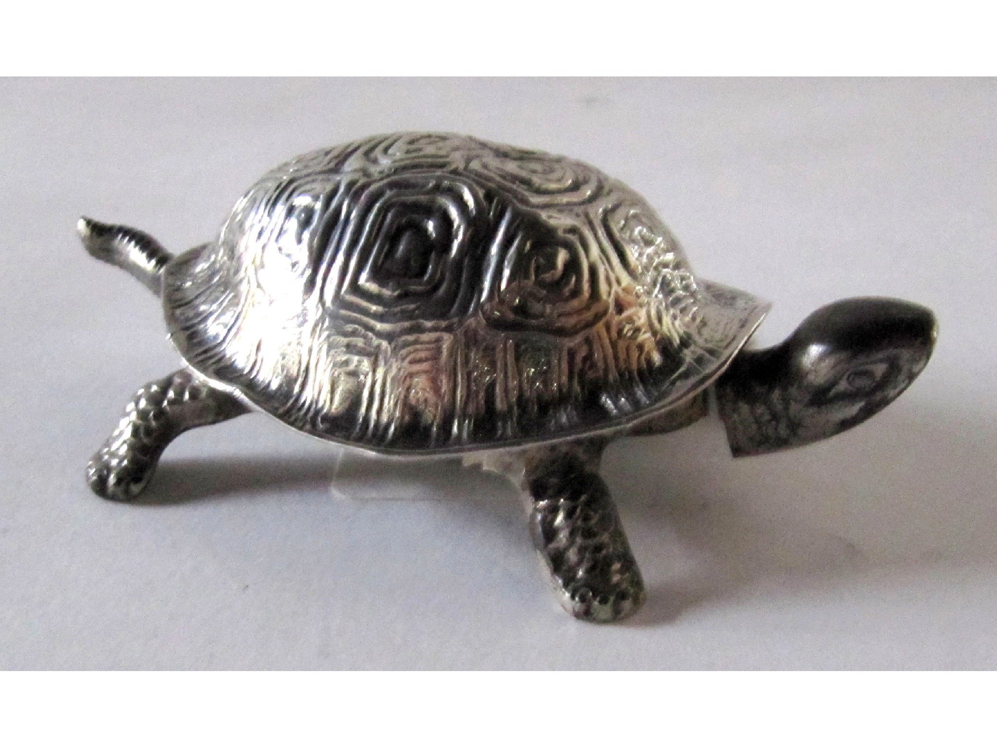 Appraisal: A silver plated reception bell modelled as a turtle