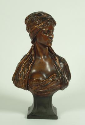 Appraisal: A GOLDSCHEIDER BUST of a young Middle Eastern lady wearing