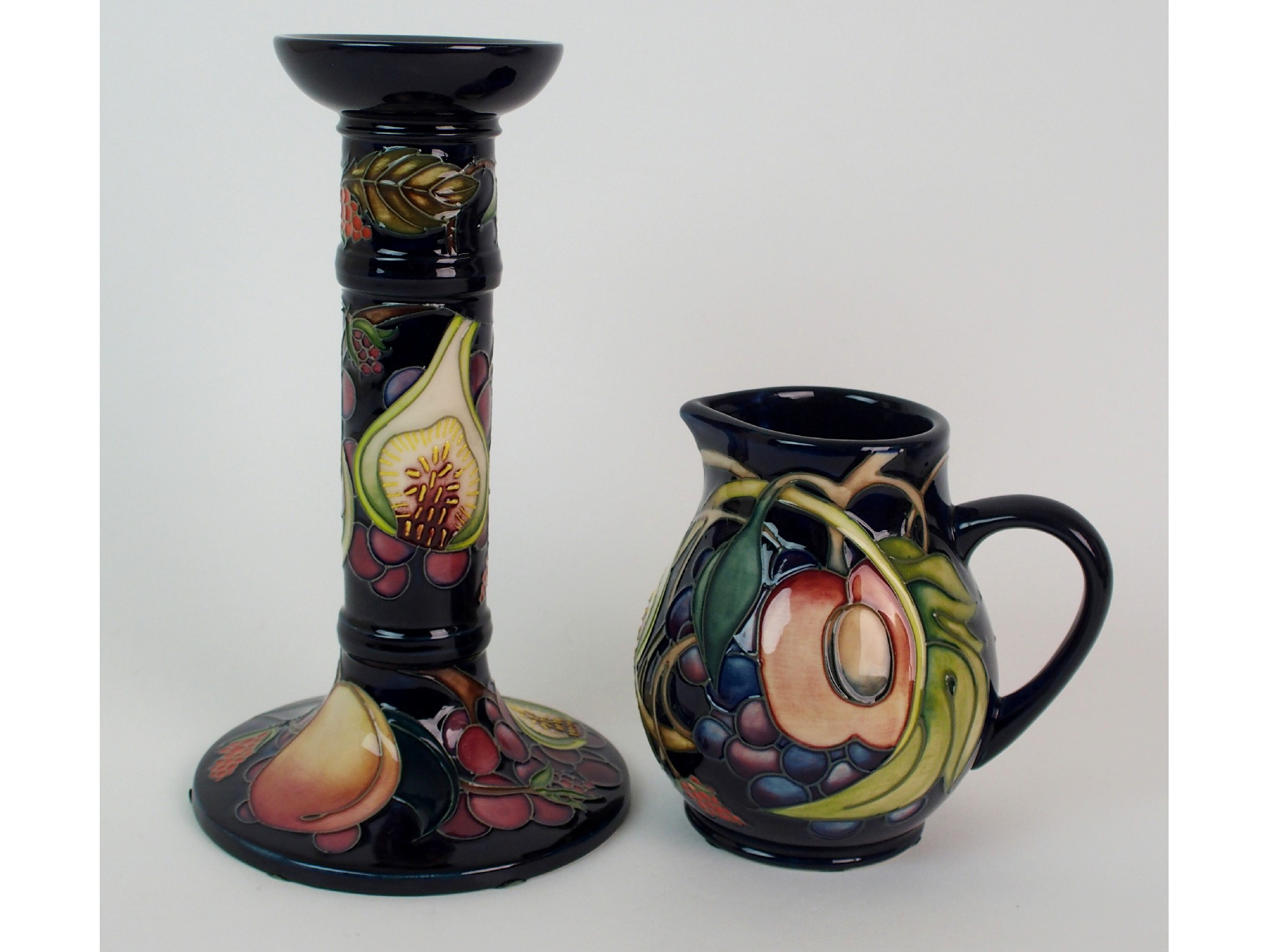 Appraisal: A Moorcroft Pottery Queens Choice candlestick and jugthe candlestick with