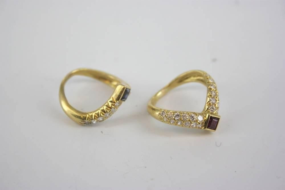 Appraisal: Pair of diamond sapphire and ruby V rings A pair