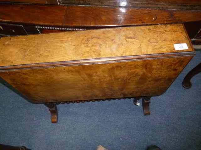 Appraisal: A VICTORIAN WALNUT VENEERED SUTHERLAND TABLE with bobbin turned supports