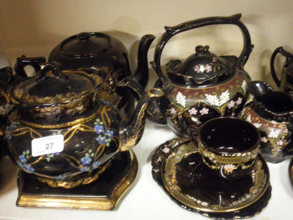 Appraisal: A Victorian black glazed teapot decorated with flowers four similar