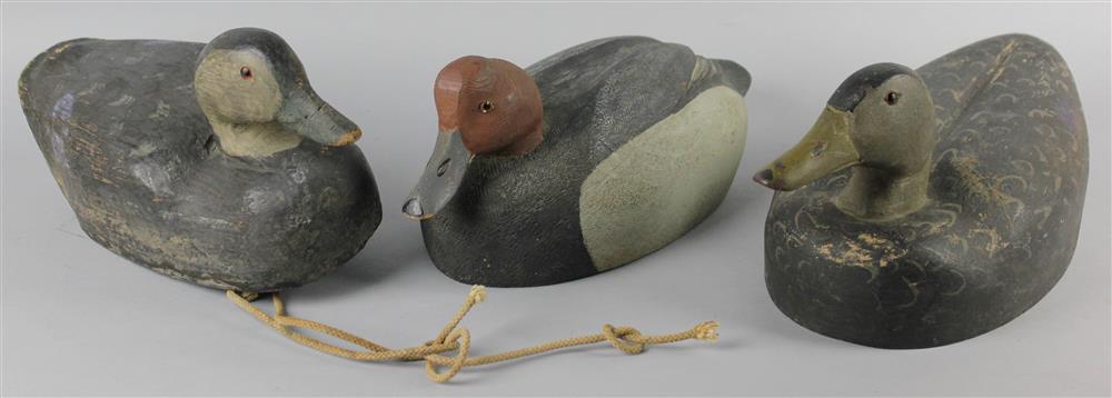 Appraisal: THREE CARVED DUCK DECOYS all unsigned the redhead drake with