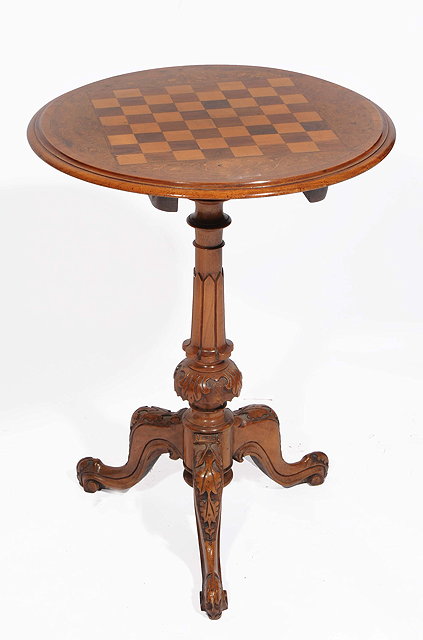 Appraisal: A VICTORIAN WALNUT CIRCULAR TILT TOP CHESS TABLE with decorative