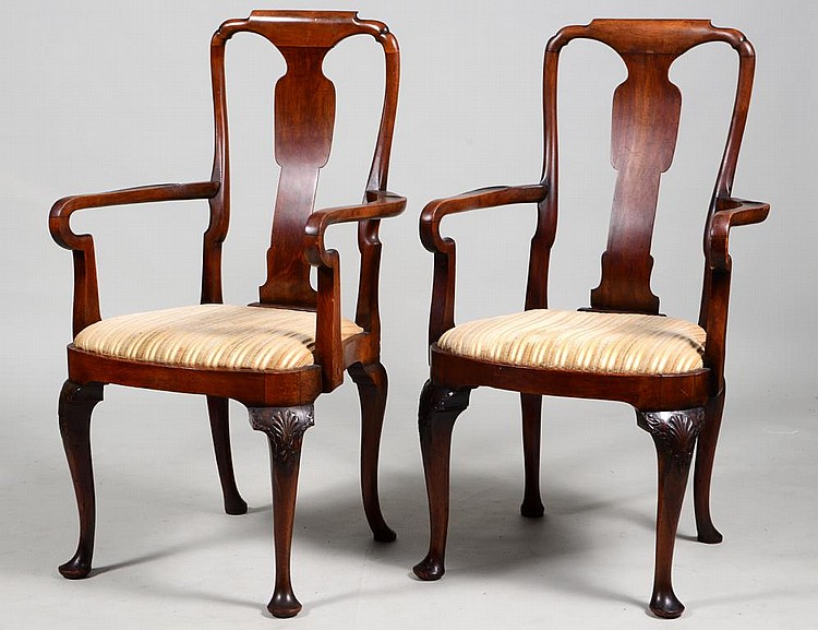 Appraisal: PAIR OF QUEEN ANNE STYLE WALNUT ARMCHAIRSThe shaped backs centering