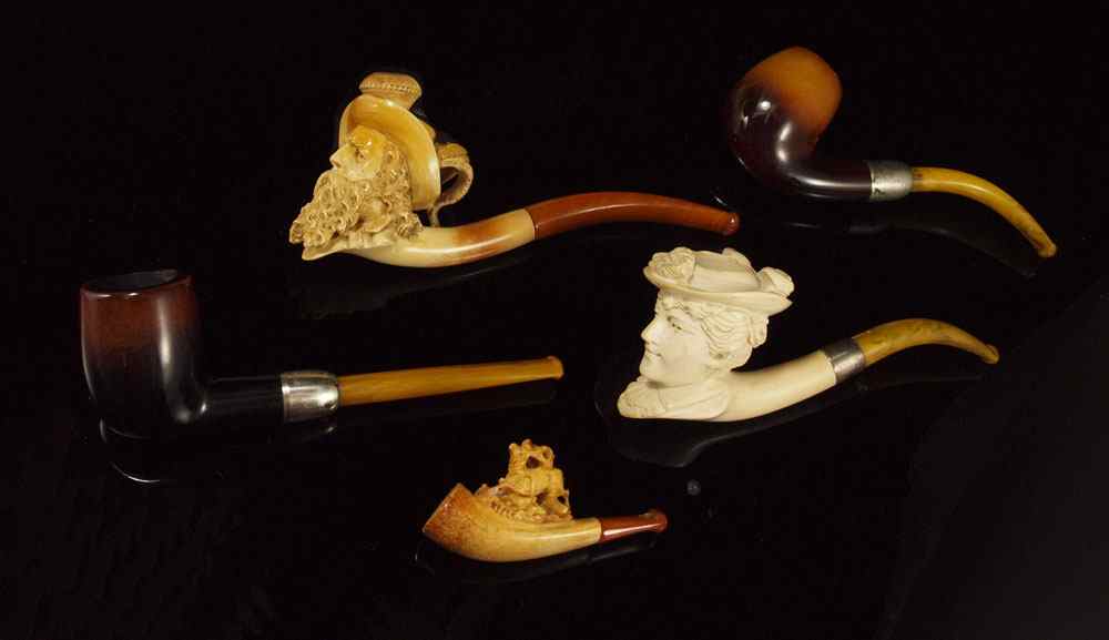 Appraisal: CARVED MEERSCHAUM AMBER STERLING PIPES To include Carved figural man