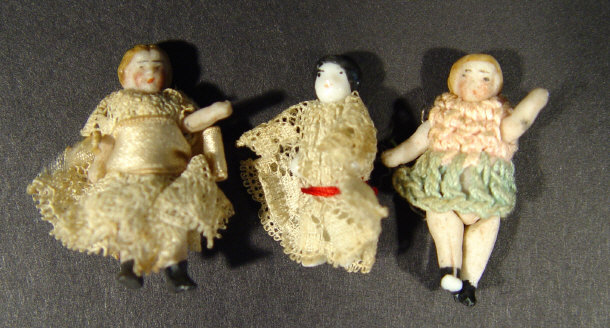 Appraisal: Three miniature china dolls in costume the largest cm high