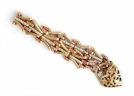 Appraisal: A bi-tone ct gold bracelet with heart shaped padlock clasp