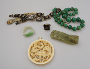 Appraisal: Green stone carved Chinese buckle button to w jade saddle