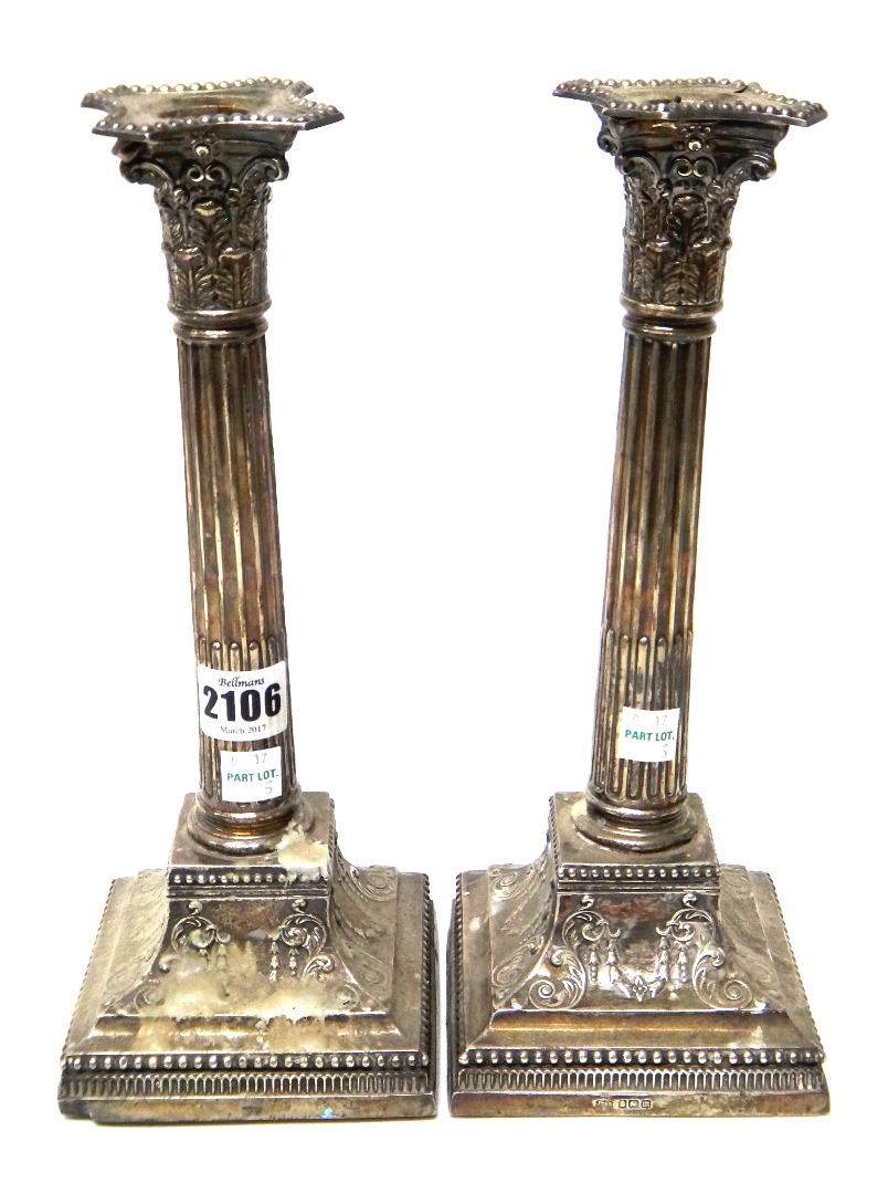 Appraisal: A near pair of silver table candlesticks each formed as