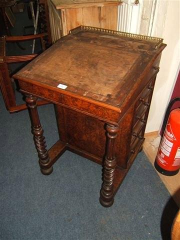 Appraisal: A Victorian burr walnut veneered Davenport with brass gallery sloping